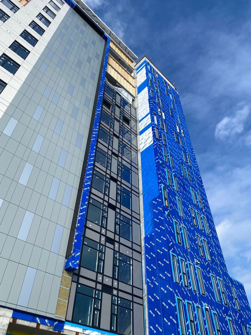 Mid-rise building mid-installation with new curtain wall glazing