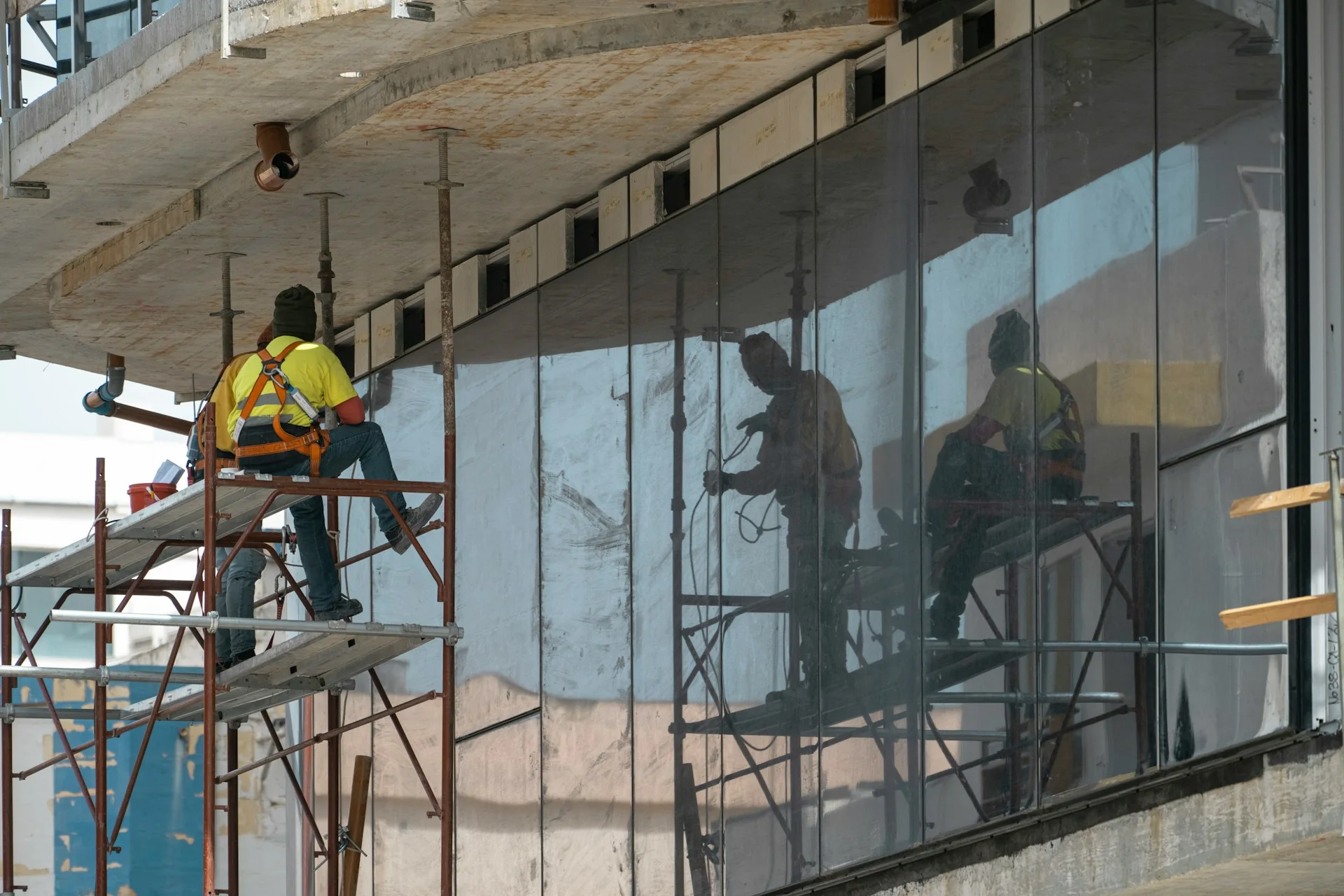 High-rise facade under protective scaffolding