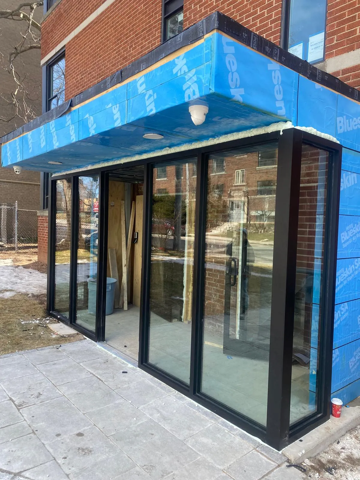 Black aluminium storefront entrance and glazed vestibule