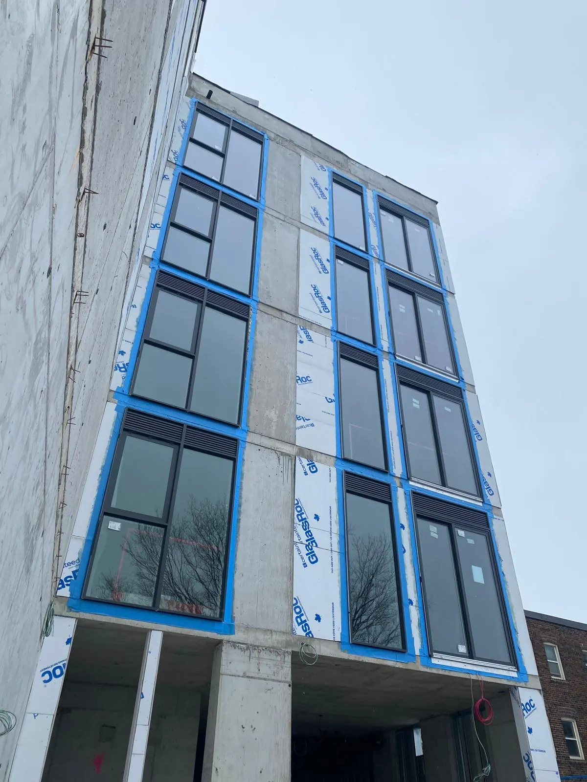 New build corner with window units set and sealed against the sheathing