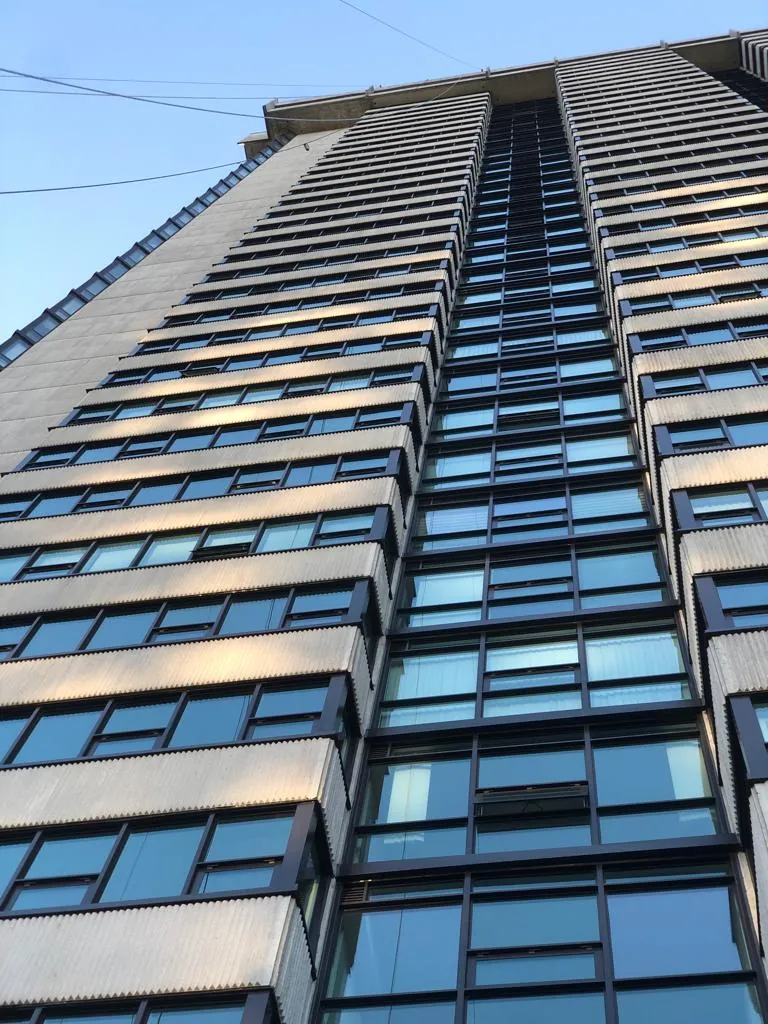 Precast tower with ribbon glazing photographed from the street